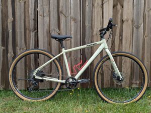 photo of a beige kona flat bar hybrid bike