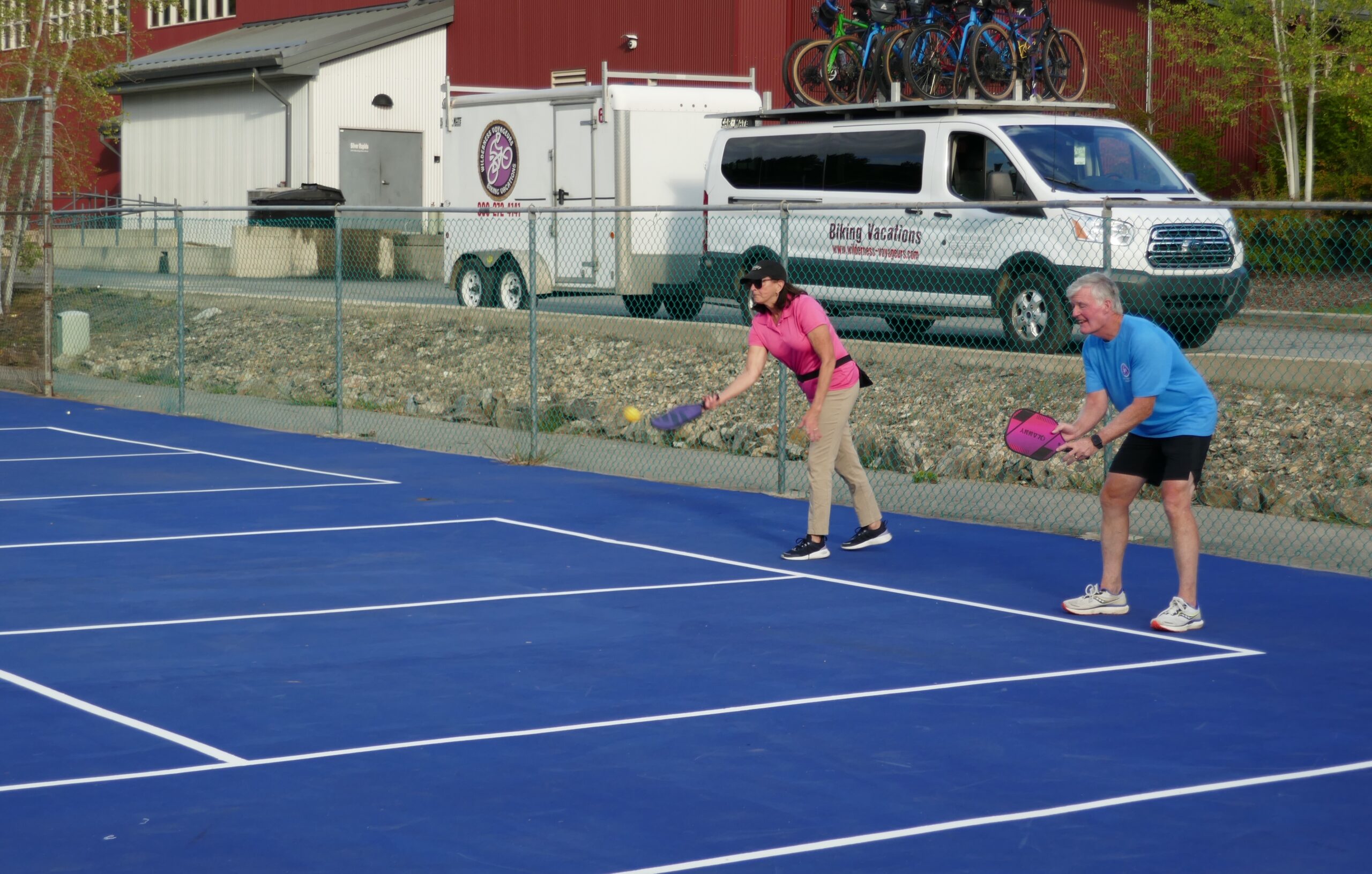 Two people playing pickleball