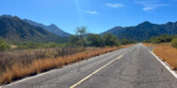 Empty road in Arizona leading to the high desert mountains