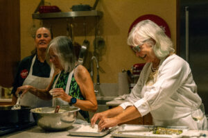 Photo of two women cooking dinner at the santa fe school of cooking