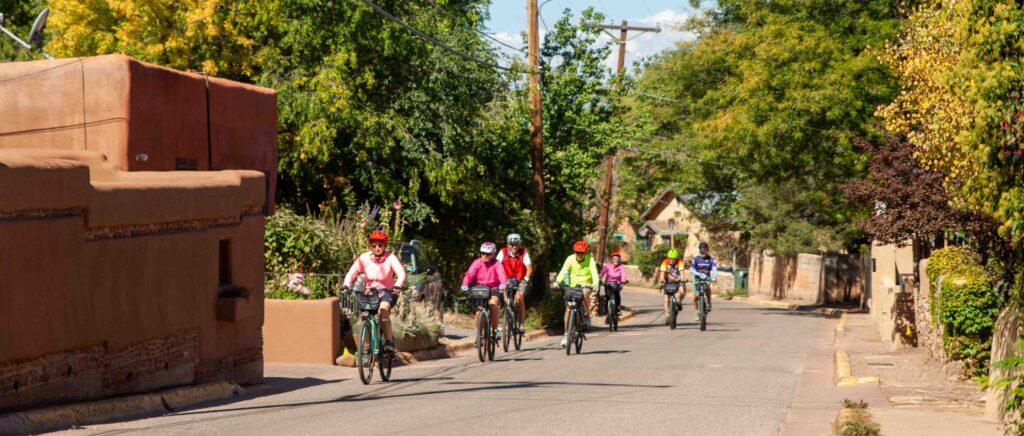 Cyclists riding up Canyon Road in Santa Fe.