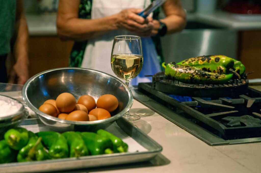 Eggs, wine, and roasting green chiles used to make chile rellenos.